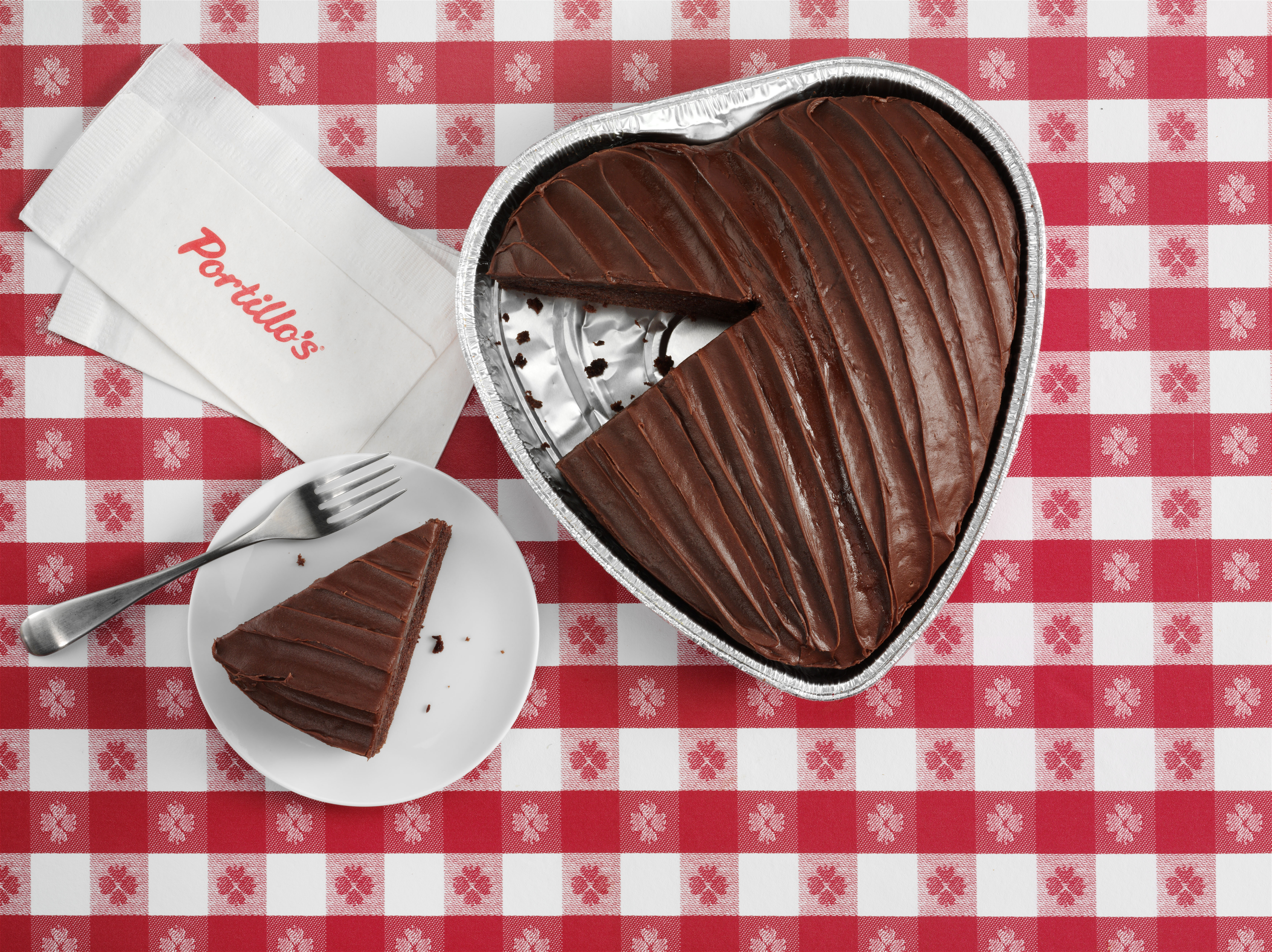 heart_cake.overhead.red_check.slice_on_plate.napkins