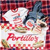 Portillo's hot dog-themed apparel and merchandise displayed on a red plaid picnic blanket.