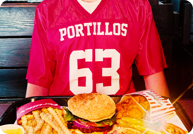 a food tray with a hamburger, fries, a hot dog and chicken nuggets