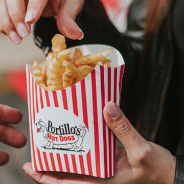 Hand reaching into french fries