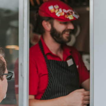 Poritllo's worker inside Beef Bus window